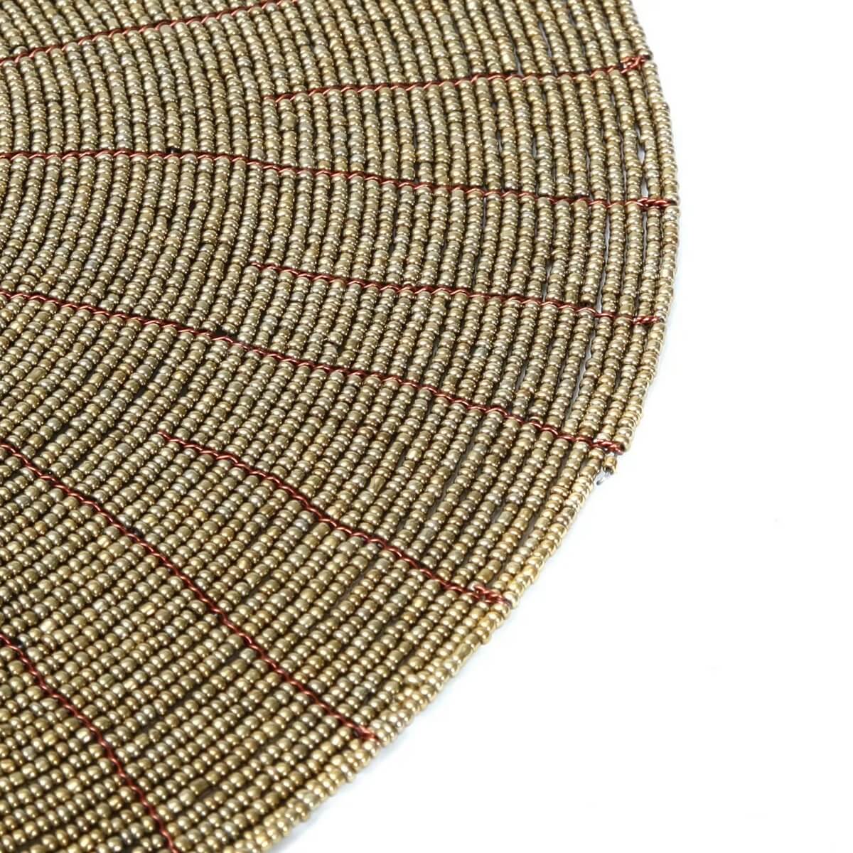Bohemian style gold beaded placemat, perfect for a chic dining setting, from Bazar Bizar Living. Size: 30cm x 30cm.