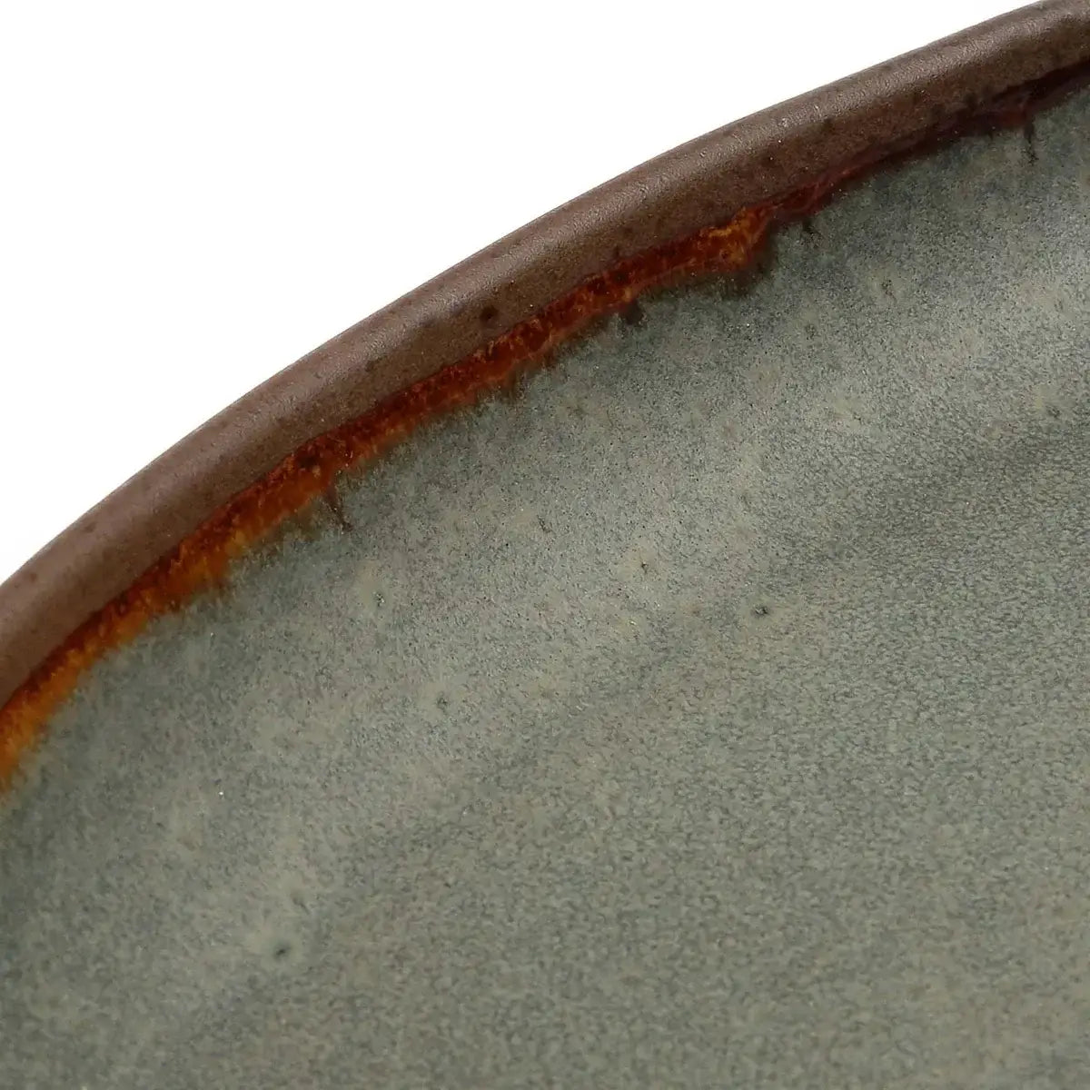 Close-up of handmade Portuguese ceramic serveware in earthy tones, showcasing unique glaze and craftsmanship.