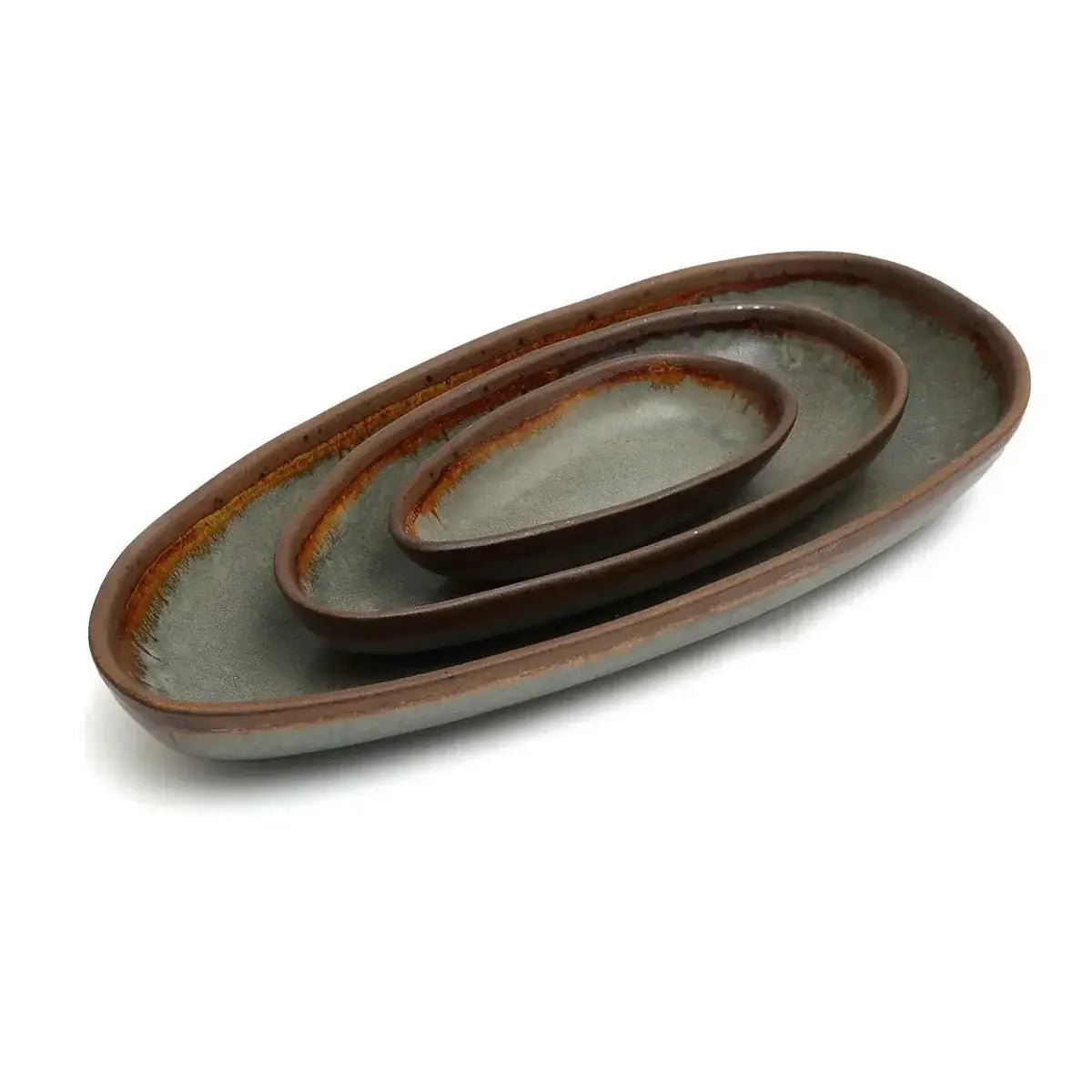 Handmade set of three oval Portuguese ceramic serving dishes with elegant finish, perfect for small bites and desserts.