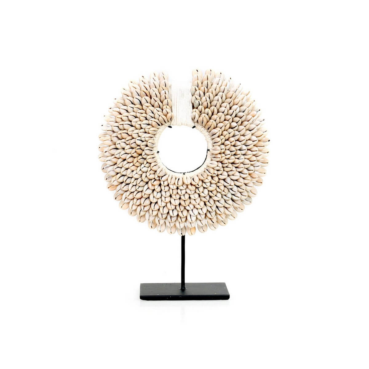 Bohemian style white shell disc on black iron stand, handmade from natural materials by Bazar Bizar Living, adds coastal elegance to decor.