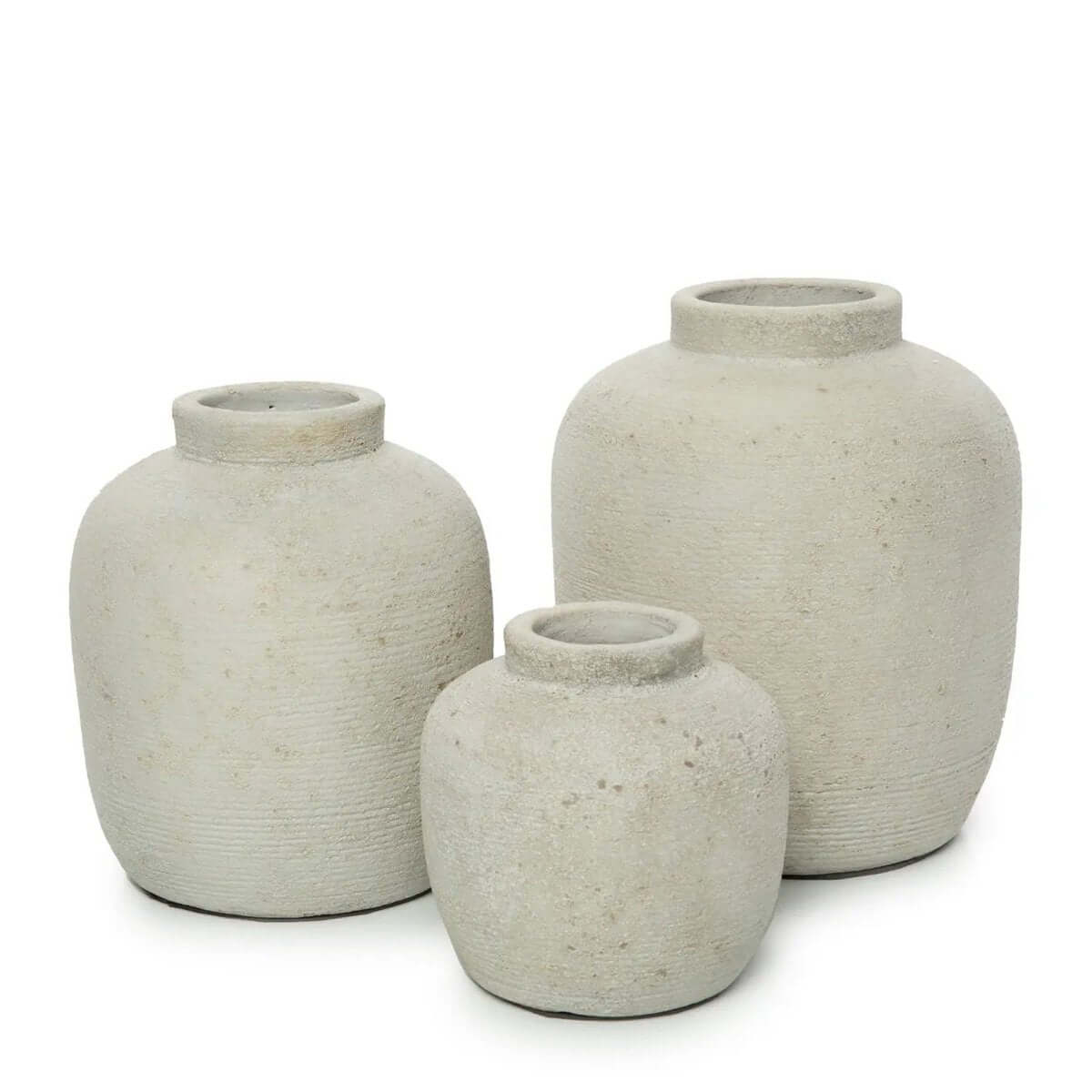 Three Bohemian style terracotta vases in minimalist design, perfect for adding charm to any space with dried or fresh flowers.