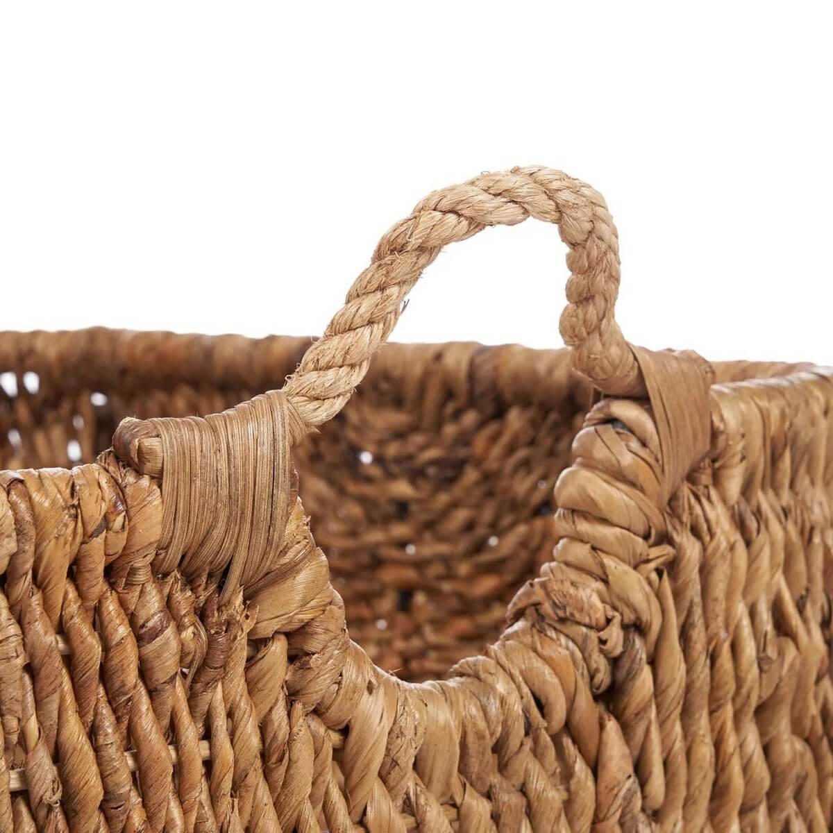 Close-up of handwoven bohemian Rayah basket made from natural banana leaf, showcasing its earthy texture and looped handle.
