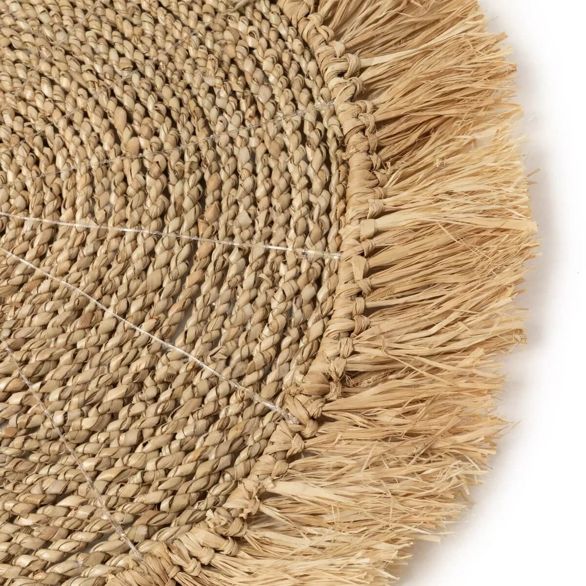 Bohemian seagrass raffia placemat in natural tones, perfect for coastal or indoor settings, adding tropical charm to your table.