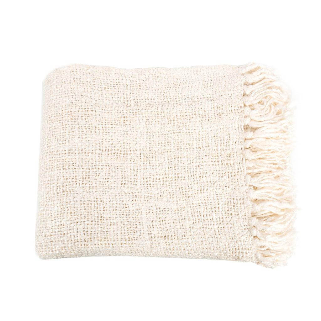 Crème handgeweven katoenen plaid met franjes, luxueuze wafelstructuur voor warme sfeer, perfect voor interieur en buiten.