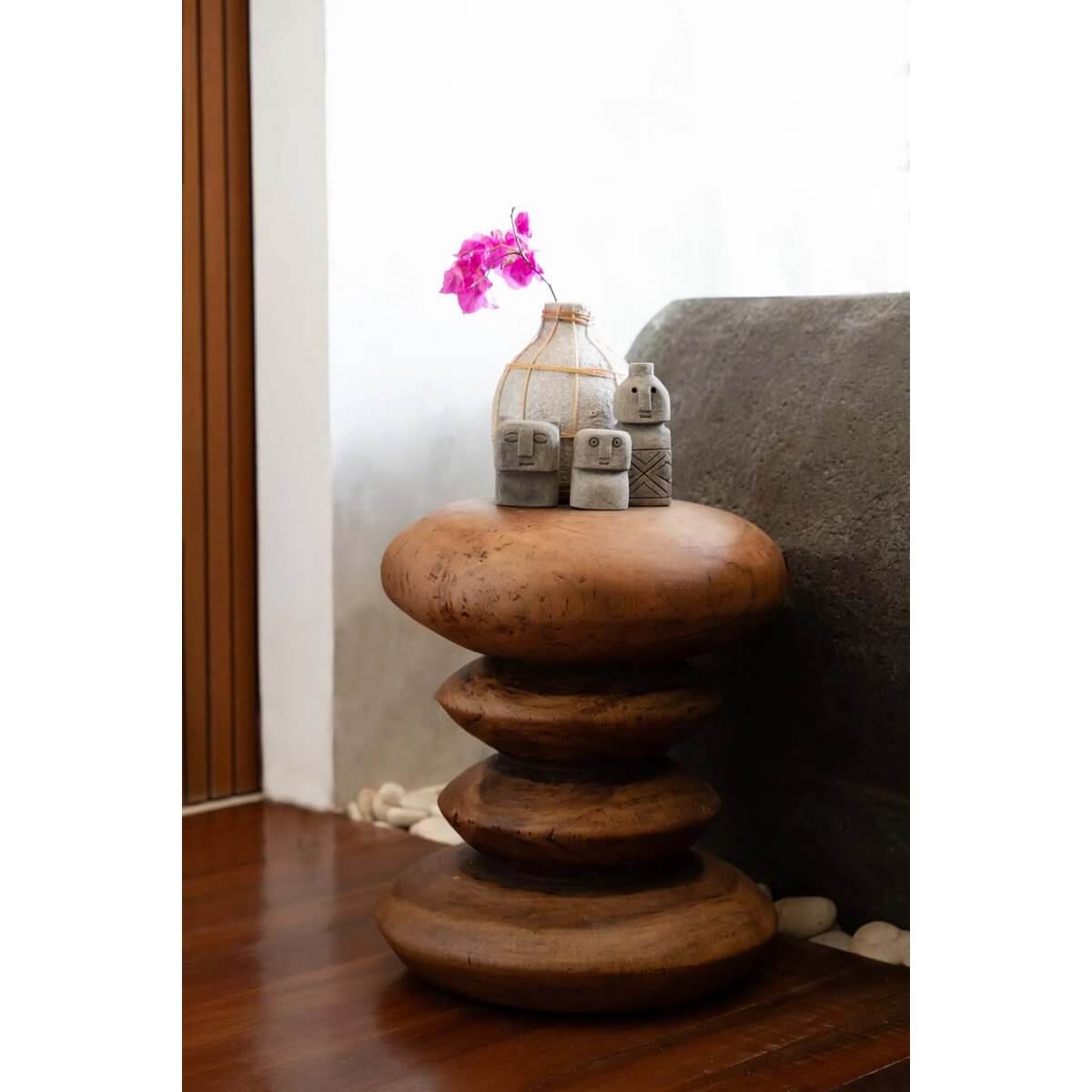 Bohemian Sumba stone statues handcrafted from sandstone, displayed on wooden pedestal for home protection and healing.