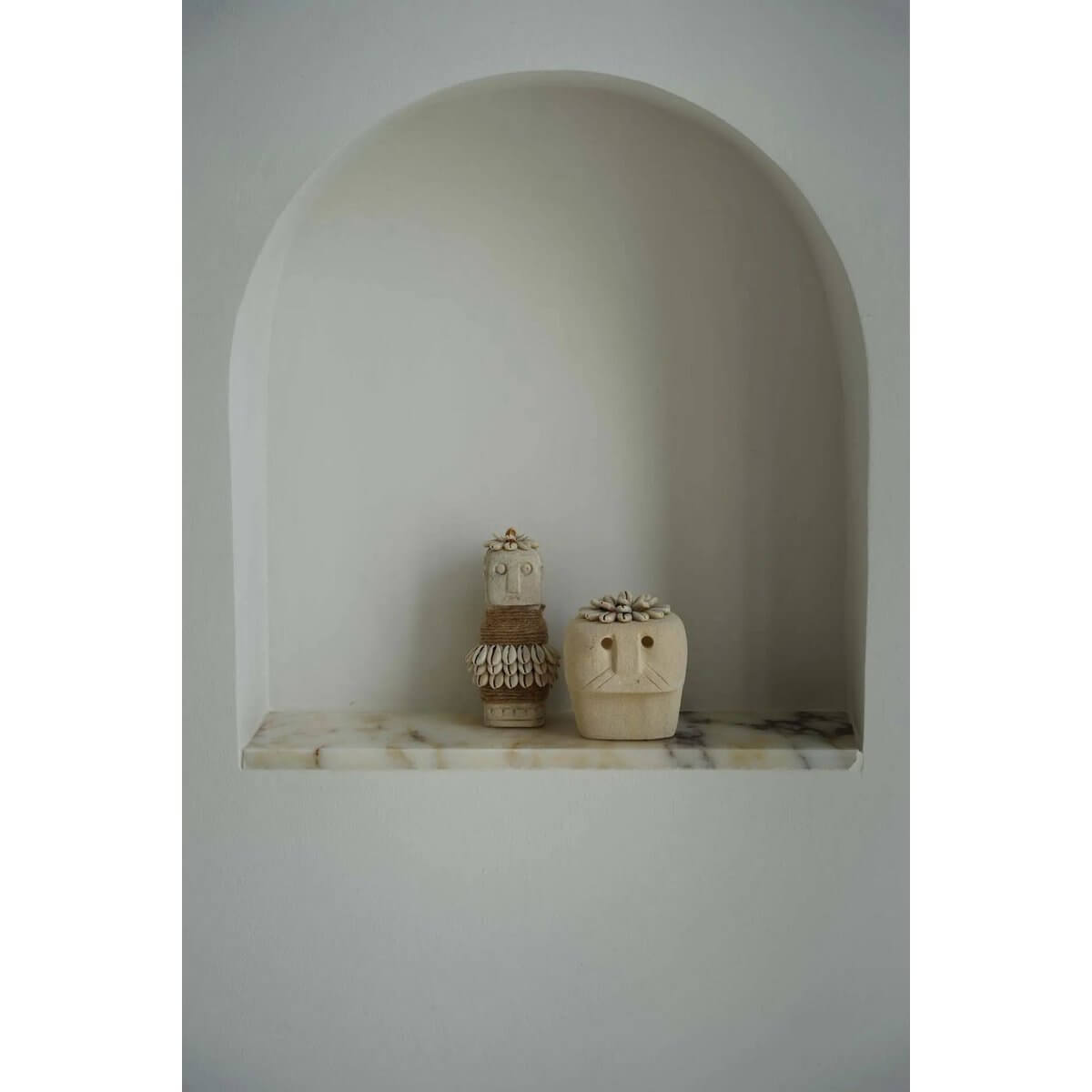 Bohemian Sumba stone statues hand-carved from sandstone, displayed in an arched niche, offering protection and healing.