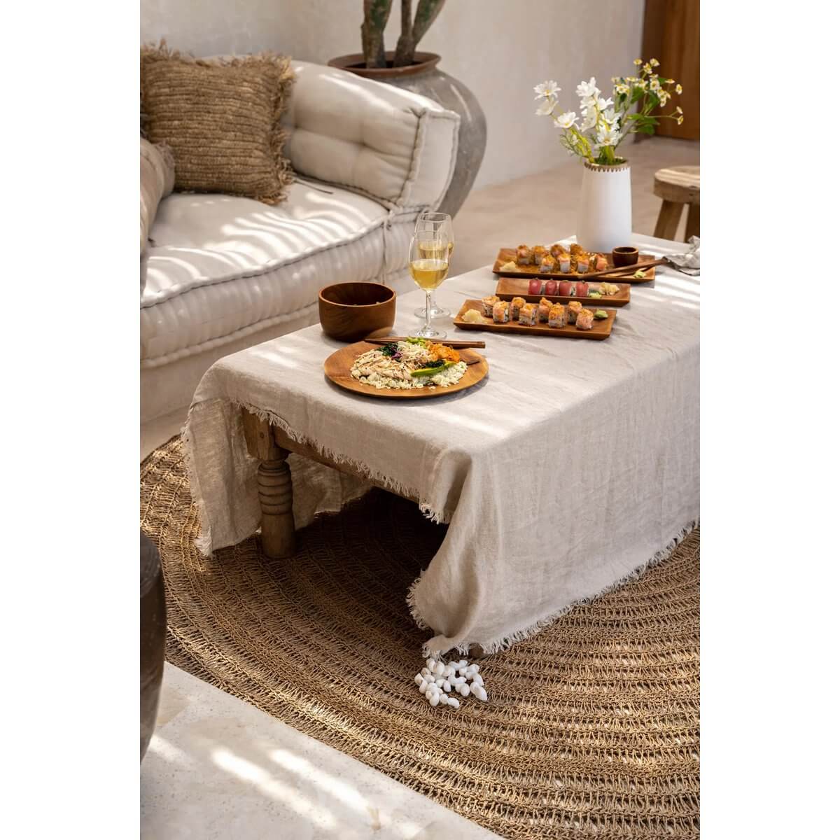 Bohemian-themed table setting with shell tablecloth hanger, showing a cozy, coastal dining style with elegance and practicality.