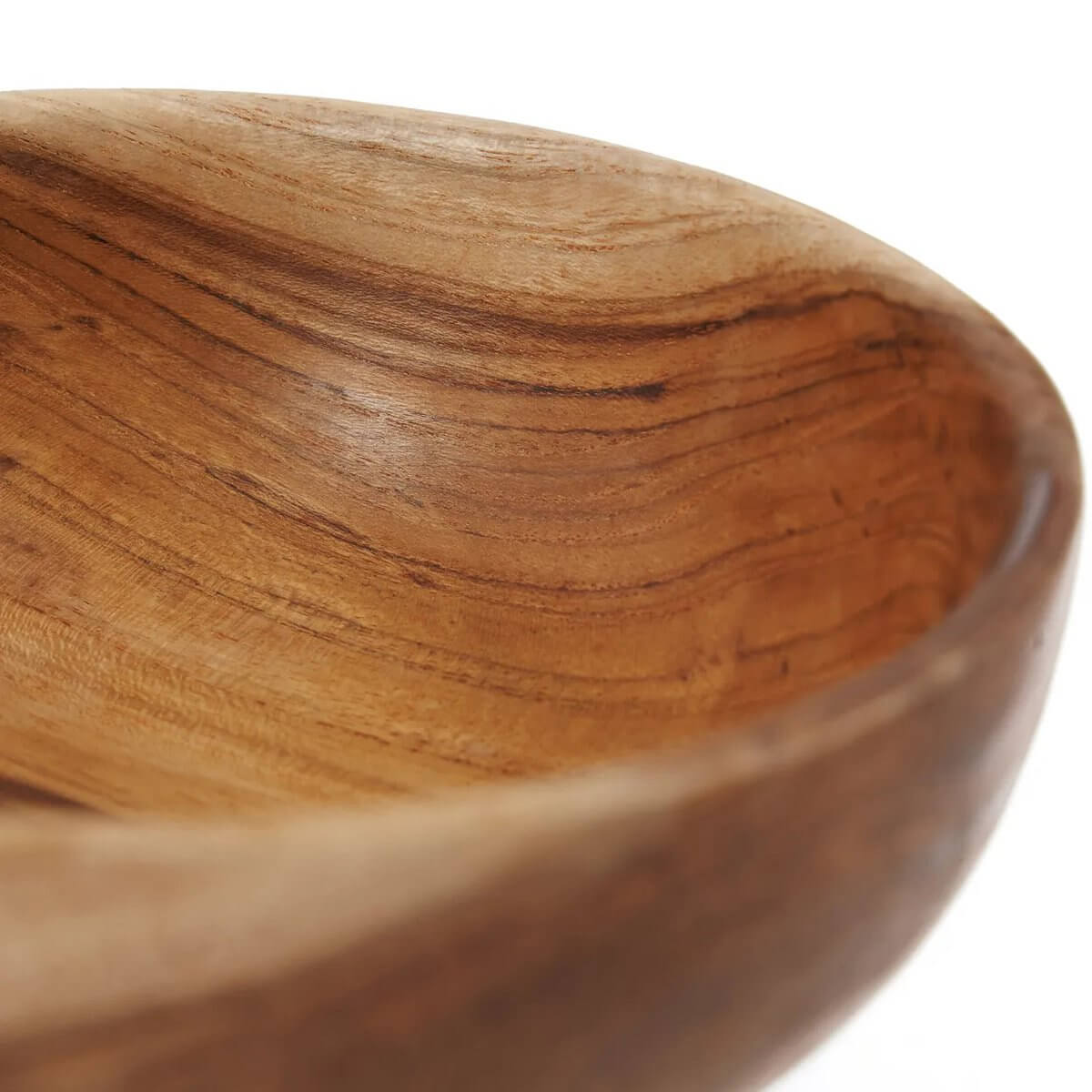 Close-up of a handcrafted teak root snack bowl, showcasing its unique grain and rustic Bohemian charm.