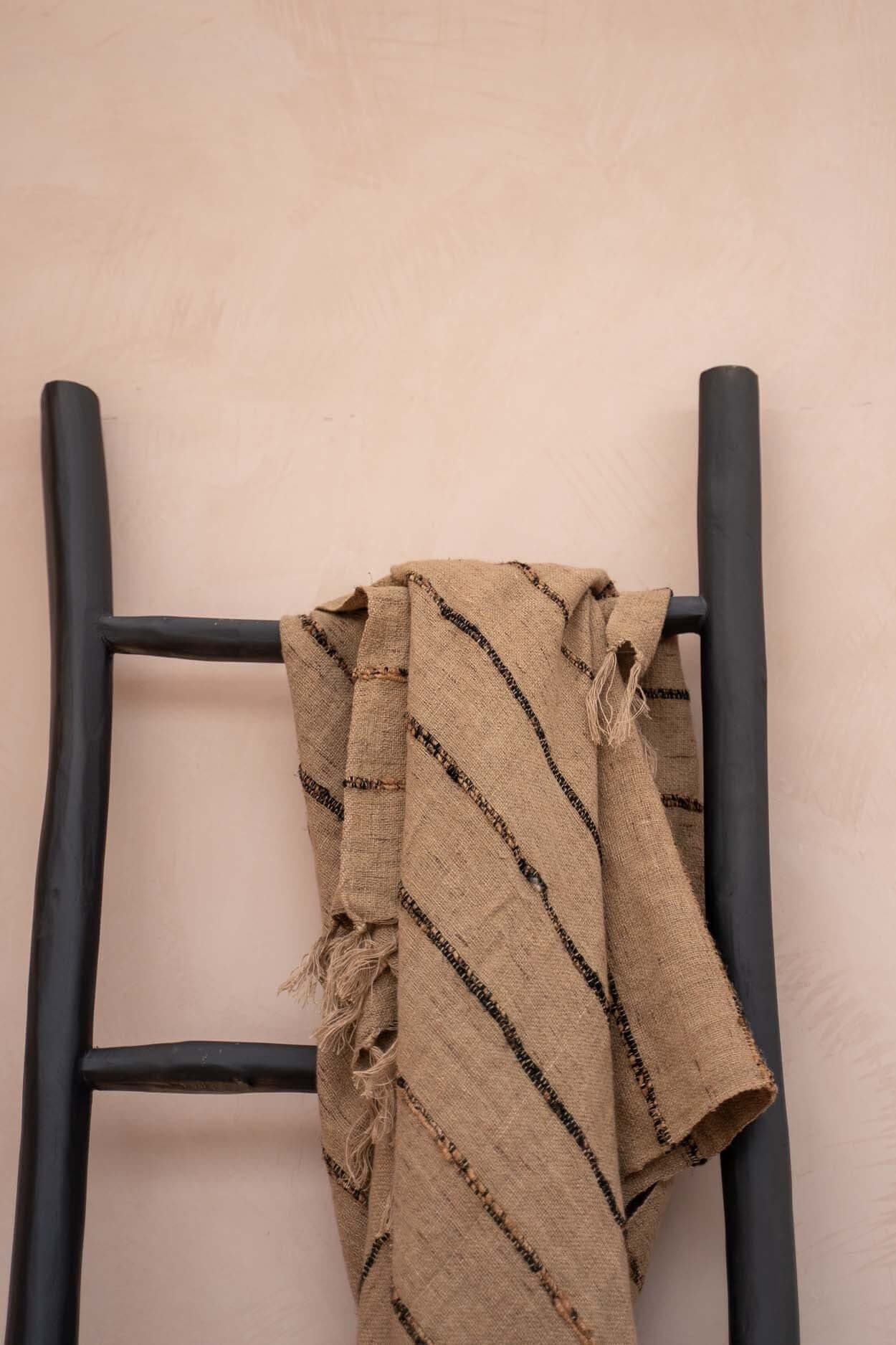 Zwarte boho ladder van teakhout met handdoek, perfect voor stijlvolle badkamer- of woonkamerdecoratie.
