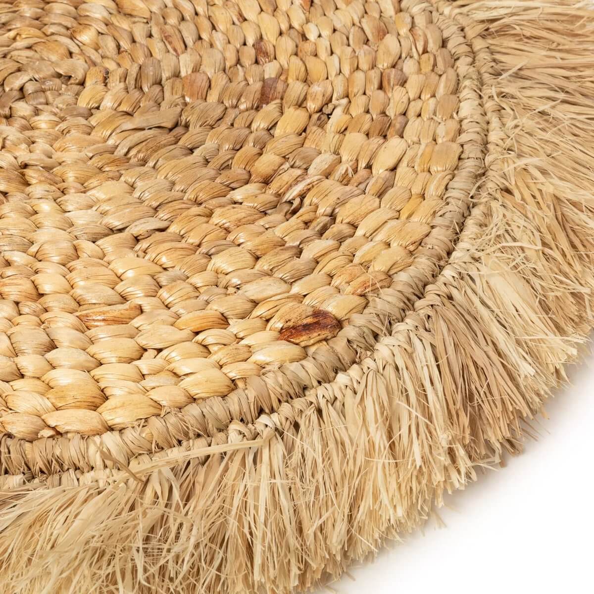 Close-up of a handcrafted De Waterhyacint Raffia Placemat in natural tones, perfect for bohemian and coastal interiors.
