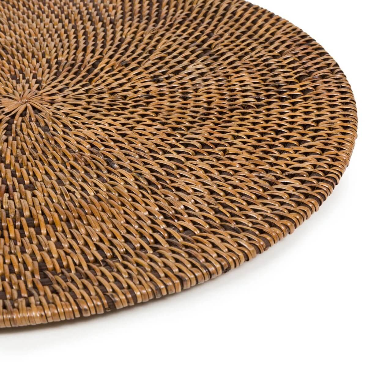 Close-up of a colonial-style, natural brown placemat with a woven design, perfect for bohemian table settings by Bazar Bizar Living.