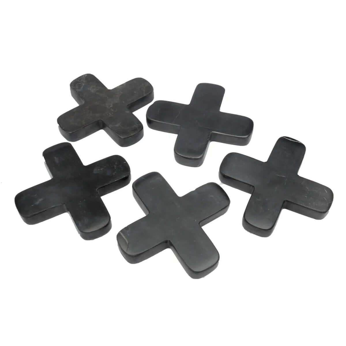 Chic Bohemian black marble cross-shaped trivets by Bazar Bizar Living, adding elegance and style to any table setting.