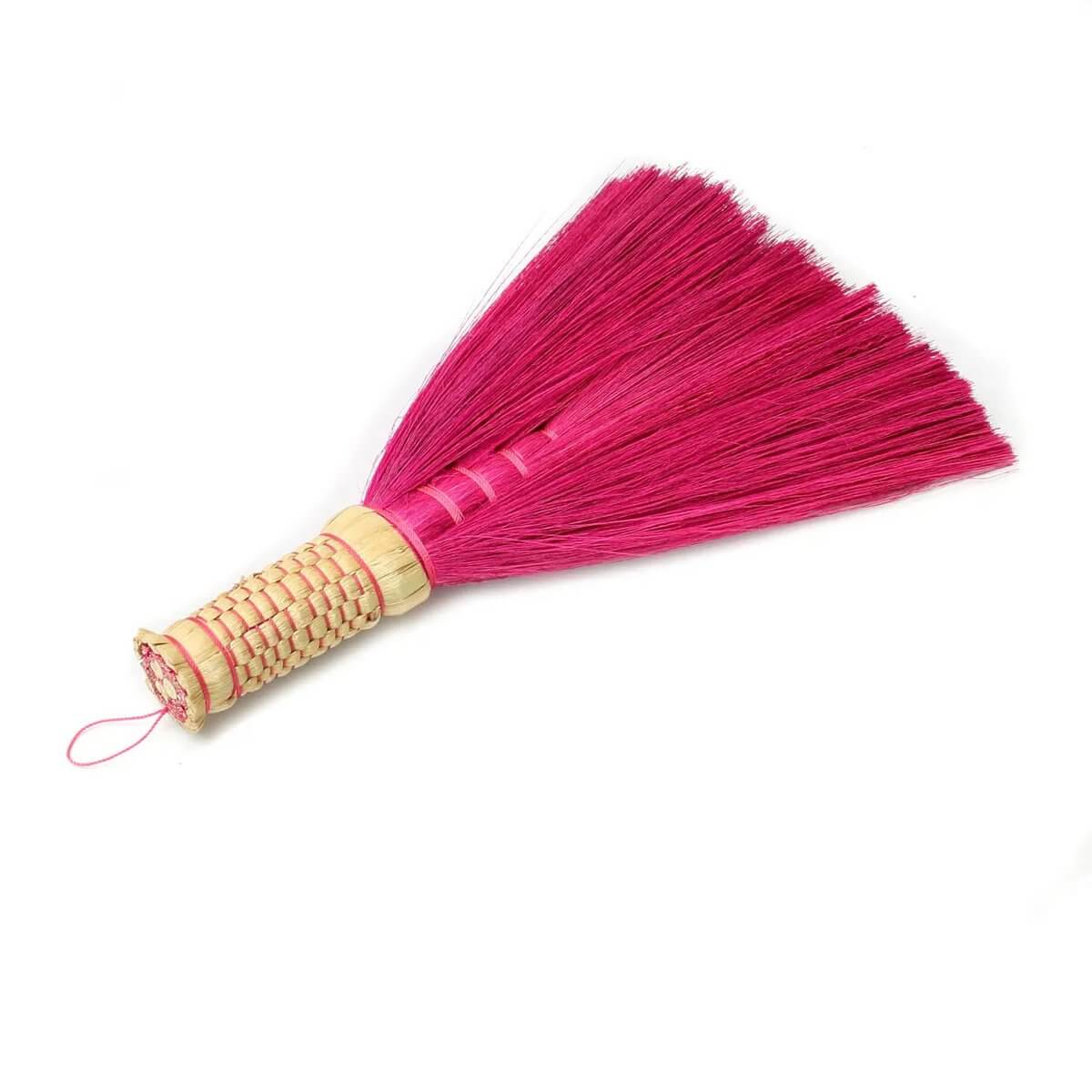 Bohemian pink Indonesian hand broom made from grass, perfect for stylish interiors and cleaning with flair.