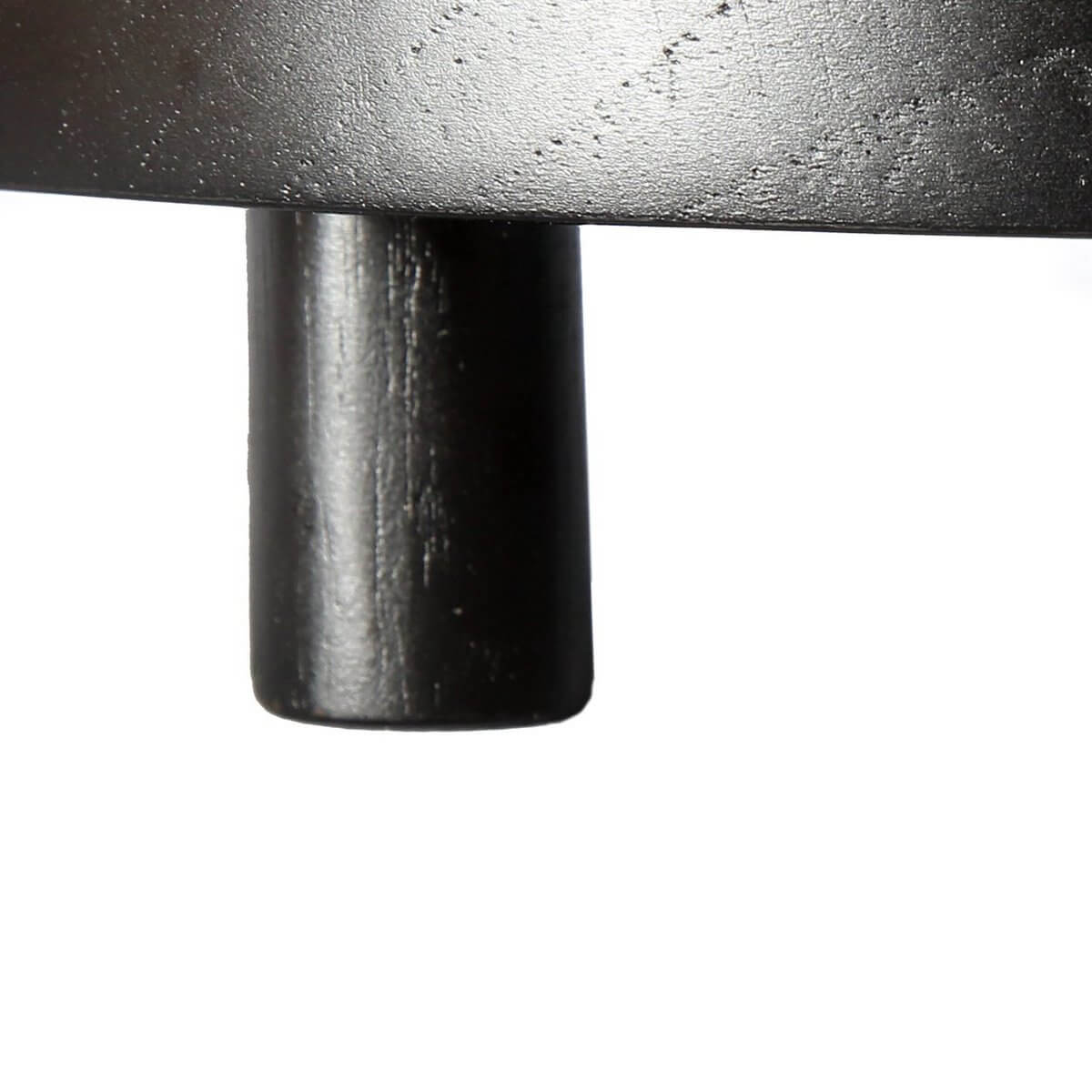 Close-up of black leg of a Bohemian-style teak wooden cake plate from Bazar Bizar Living.