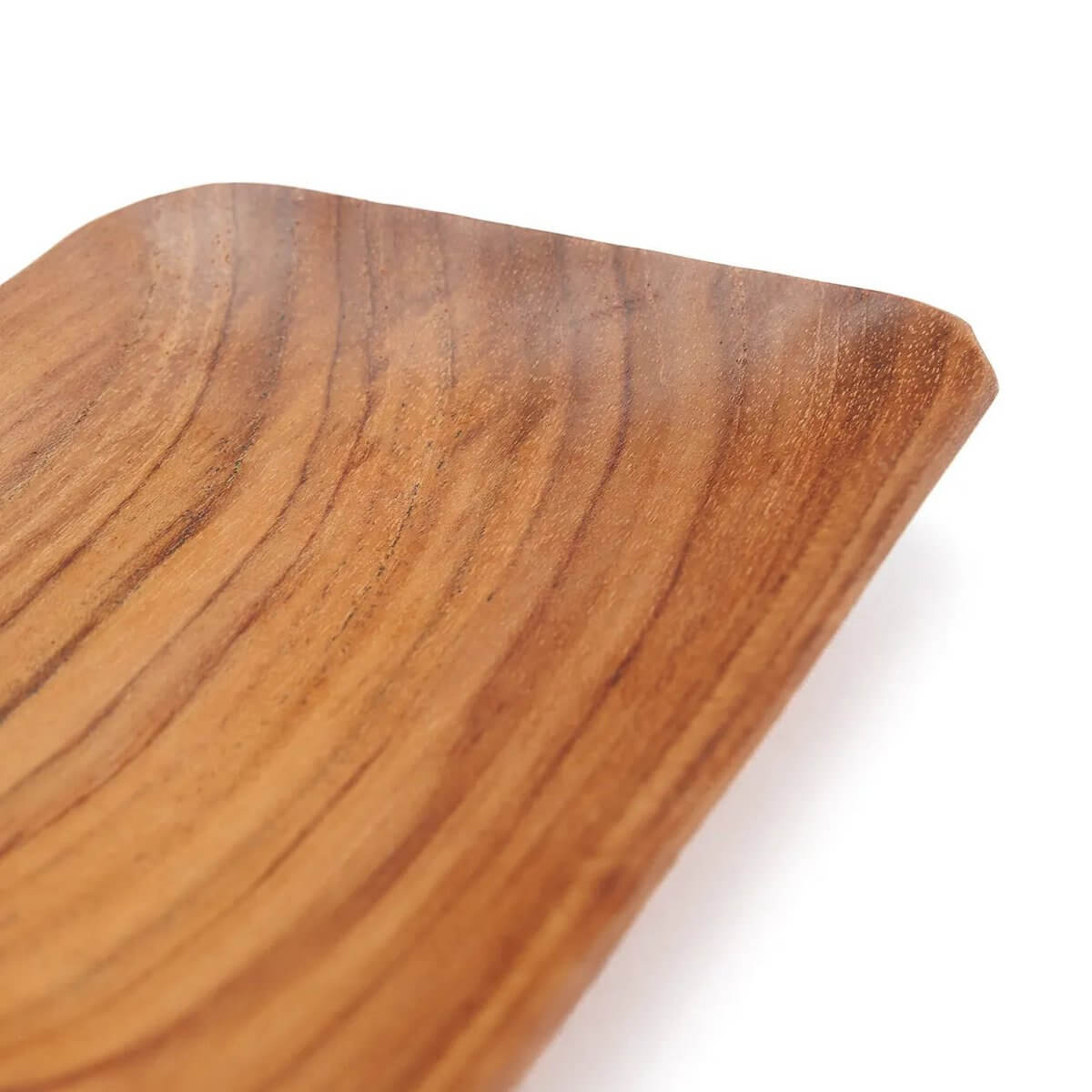 Close-up of rectangular handcrafted Bohemian teak root dish with natural wood patterns, ideal for serving side dishes.