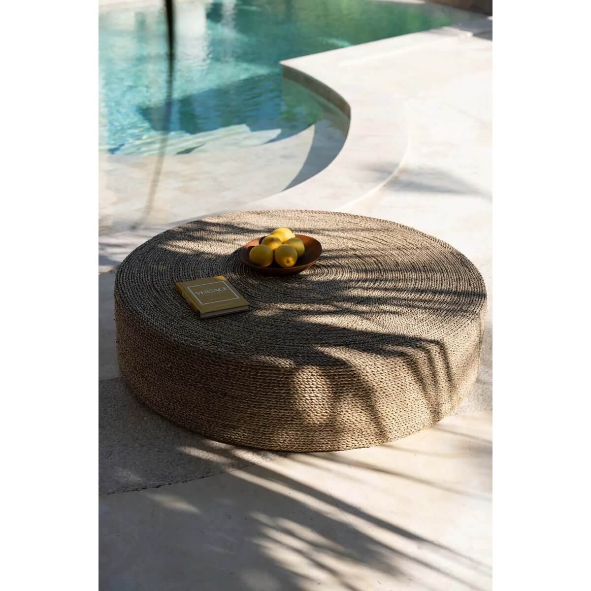 Bohemian style teak root board with fruit, natural tones and textures, near a sunlit poolside setting, evoking relaxation.
