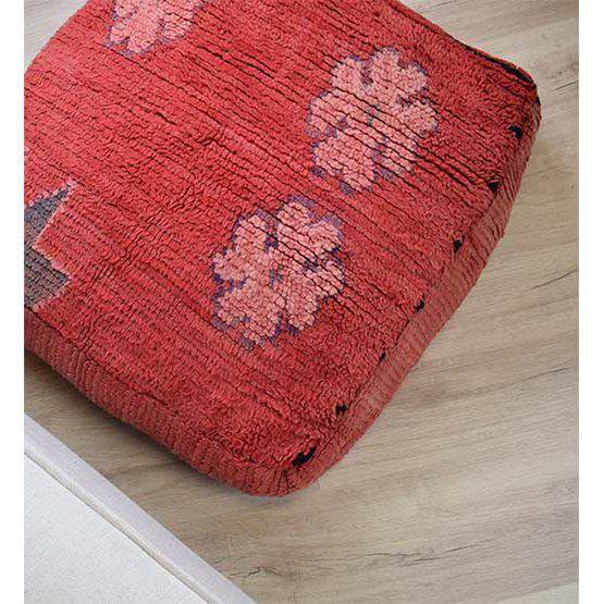 Handgemaakt Marokkaans vloerkussen K818 met rode aardse kleuren en traditionele geometrische patronen, op houten vloer.