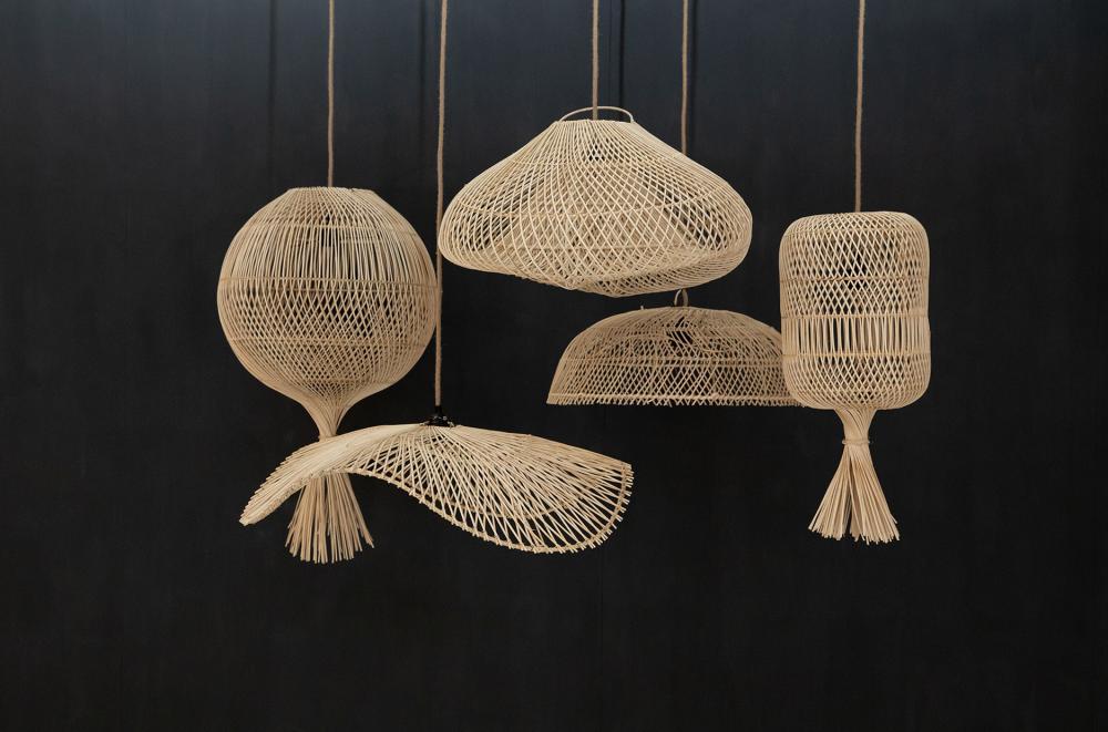 Vijf unieke rotan hanglampen in bohemian stijl tegen een zwarte achtergrond.