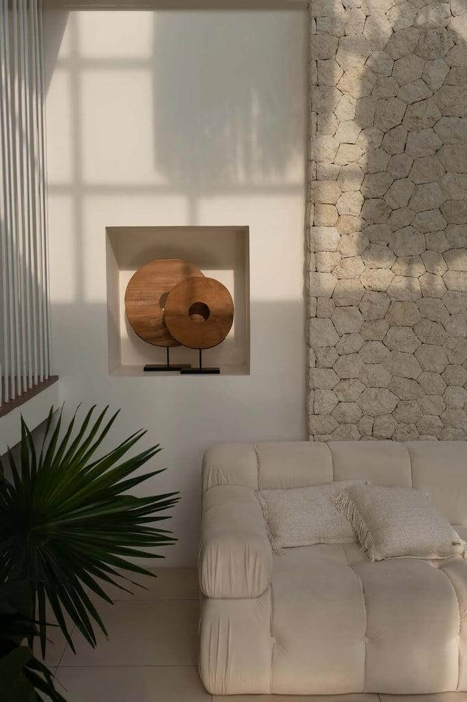 Teakhouten cirkel op standaard in Ibiza interieur met ecovriendelijke materialen en natuurlijke uitstraling.