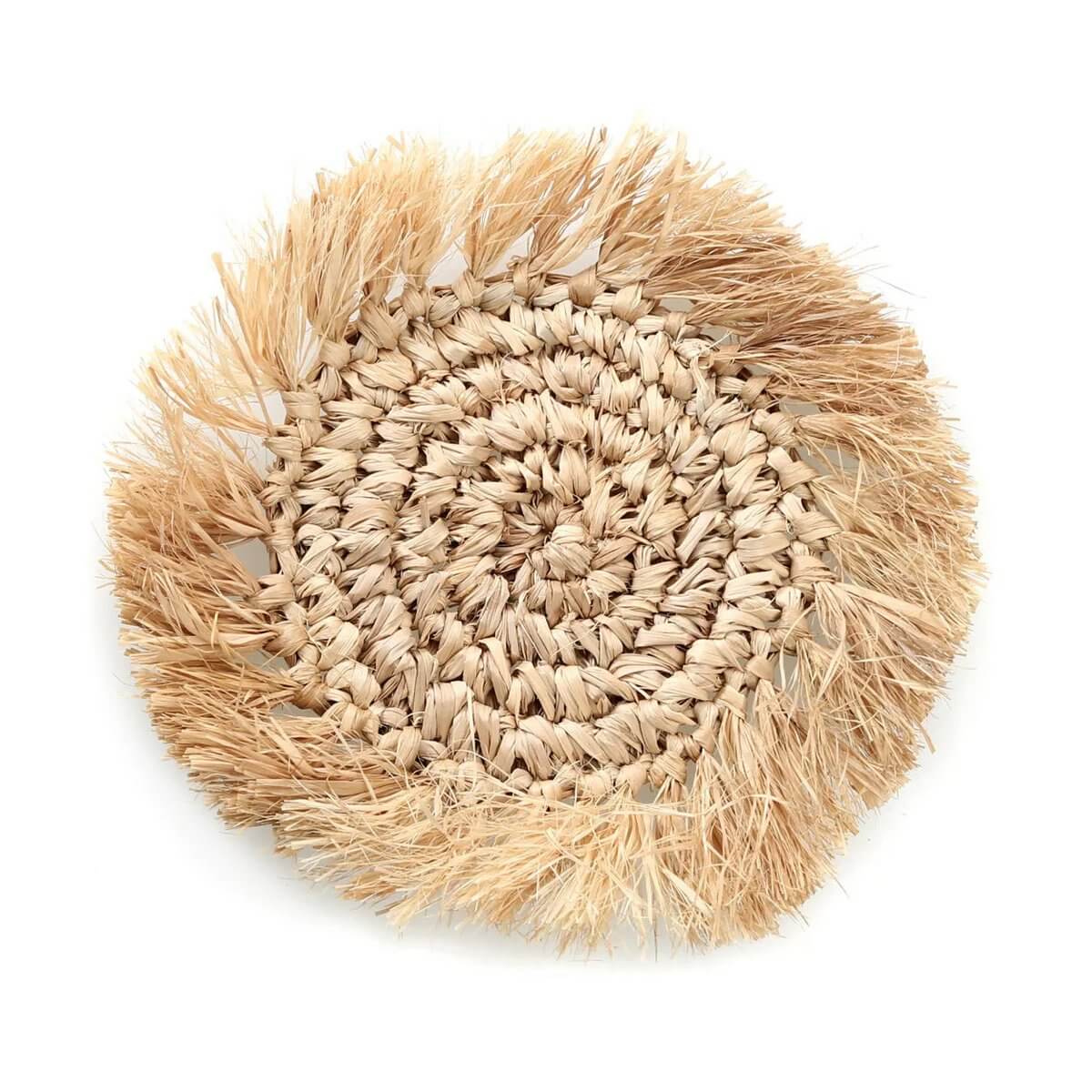Bohemian style natural raffia coaster with fringe, perfect for coffee tables or paired with our raffia placemat. Lightweight and neutral.