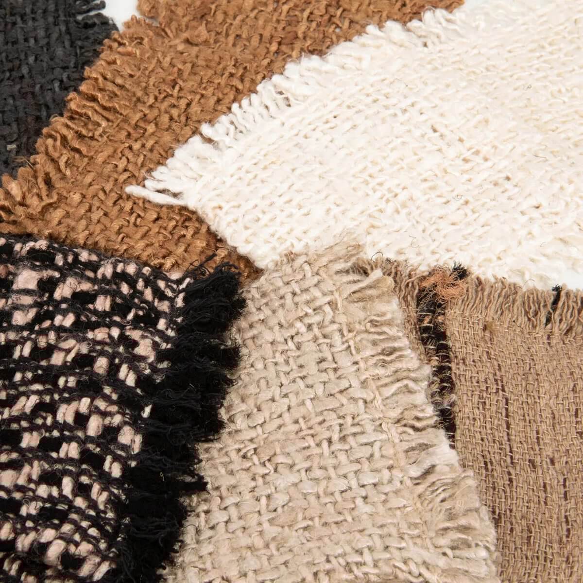 Textured fabric patterns in beige, black, and brown, showcasing a bohemian style for The Oh My Gee Bestekhouder set.