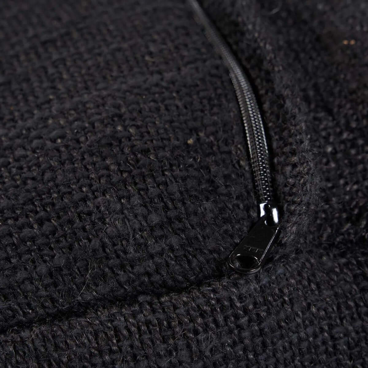 Close-up van zwarte comfortabele poef met rits, ideaal voor extra zitcomfort in huis.