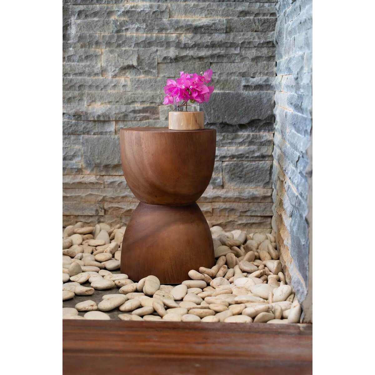 Bohemian Azure kruk made of suarhout, doubles as a chic side table, featuring unique hand-made design, set on pebbles.