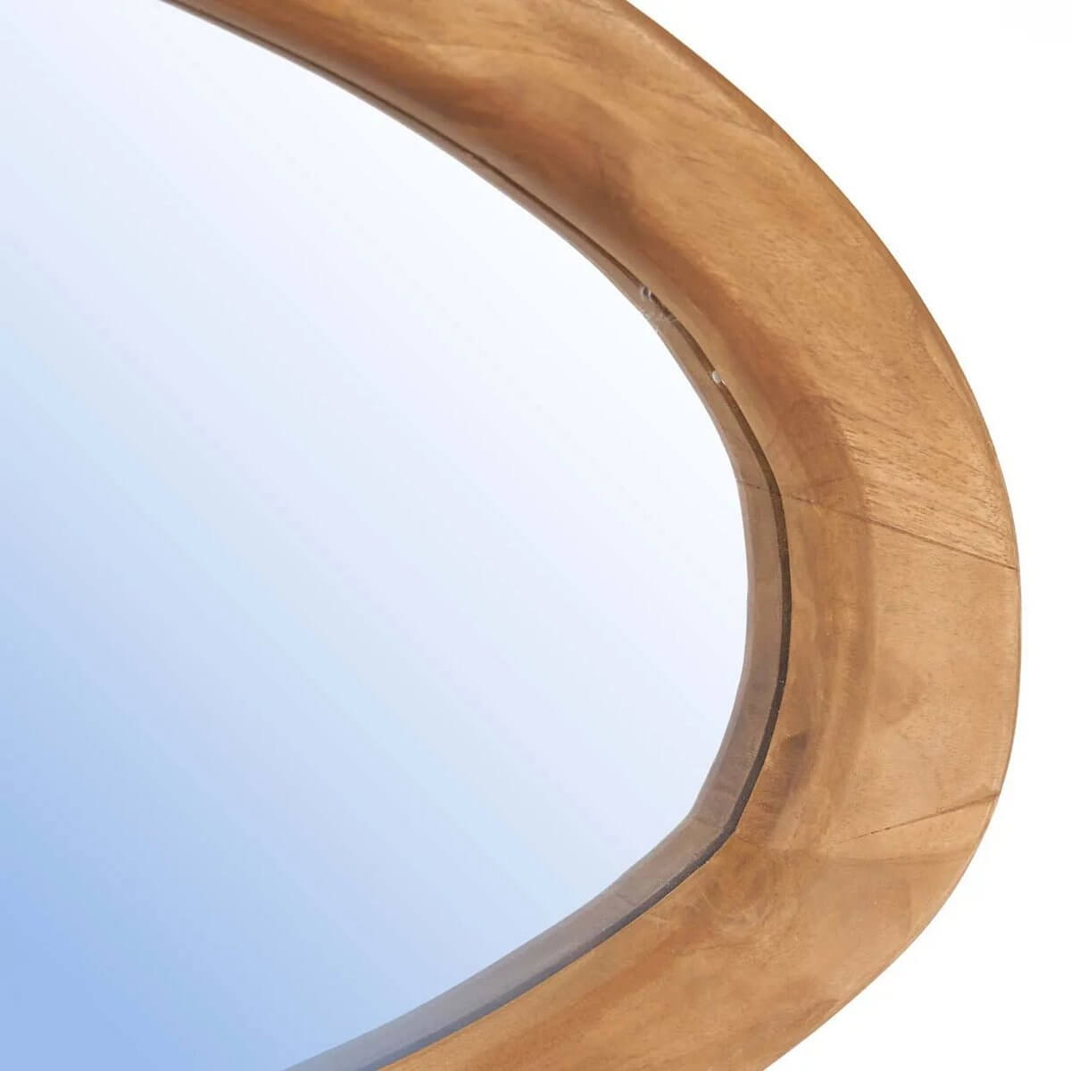 Close-up of an organic mirror with rich teakwood frame, showcasing bohemian style and natural beauty.