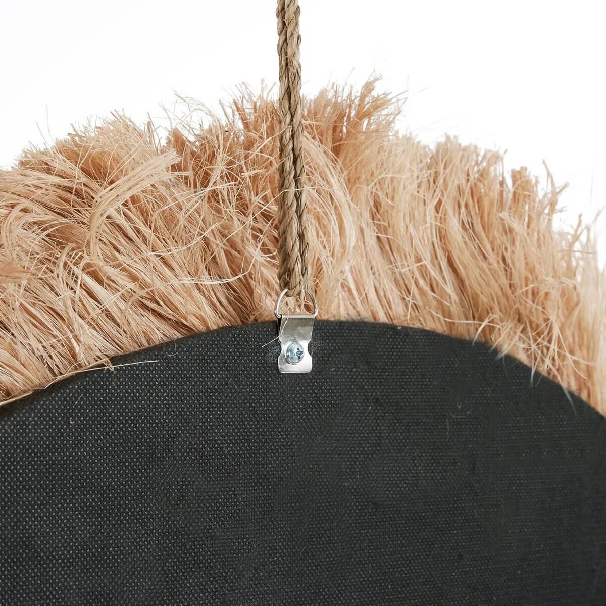 Close-up of sustainably crafted Bohemian mirror with natural grass frame, inspired by the sunlit shores of Capri.