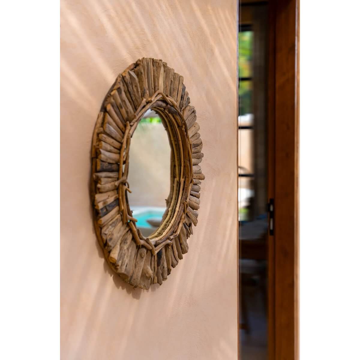 Bohemian style driftwood mirror on a wall, showcasing natural texture and unique design, perfect for creating an accent wall.