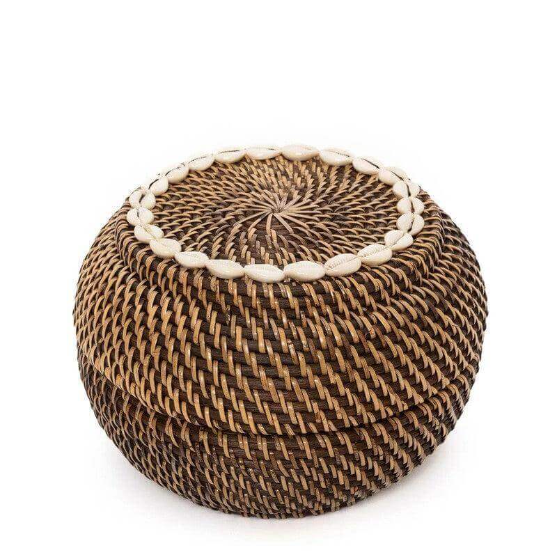 Schattige opbergmand van donker rotan, versierd met kaurischelpen. Perfect voor het opbergen van sieraden of badkamerartikelen.