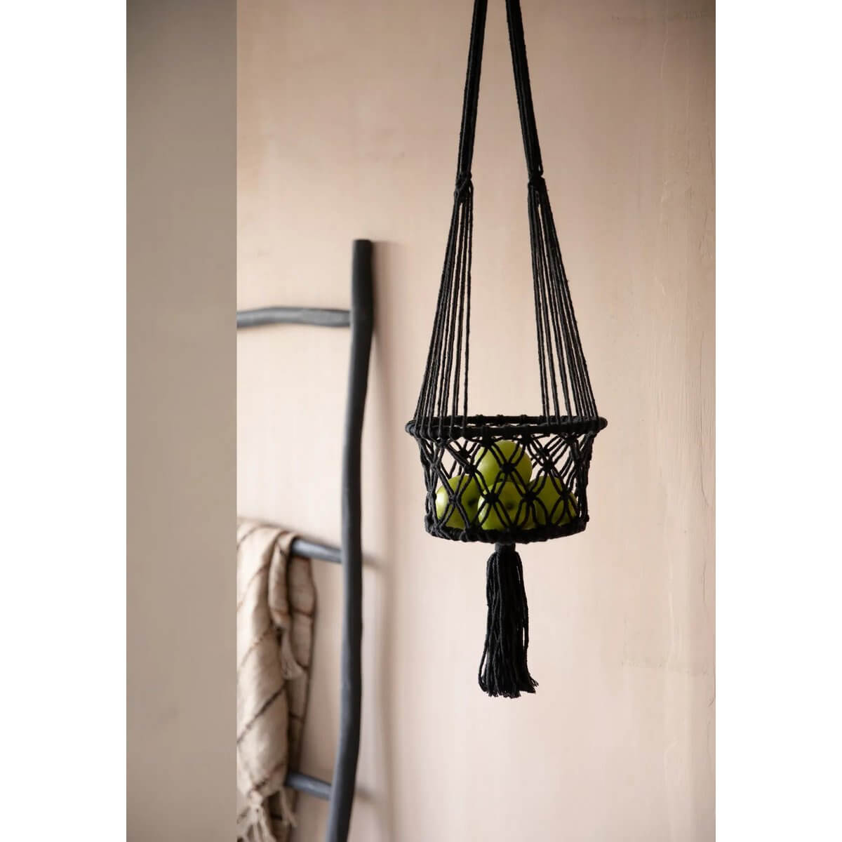 Bohemian black macramé plant holder with green apple, perfect for indoor decor, by Bazar Bizar Living.