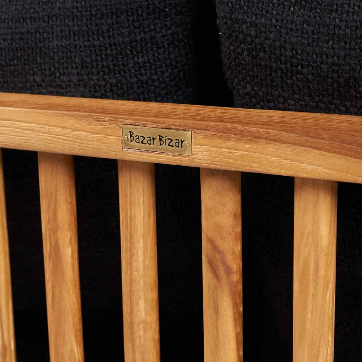 Close-up of teak wood frame with Bazar Bizar label on the De Malawi Bohemian-style two-seater sofa.