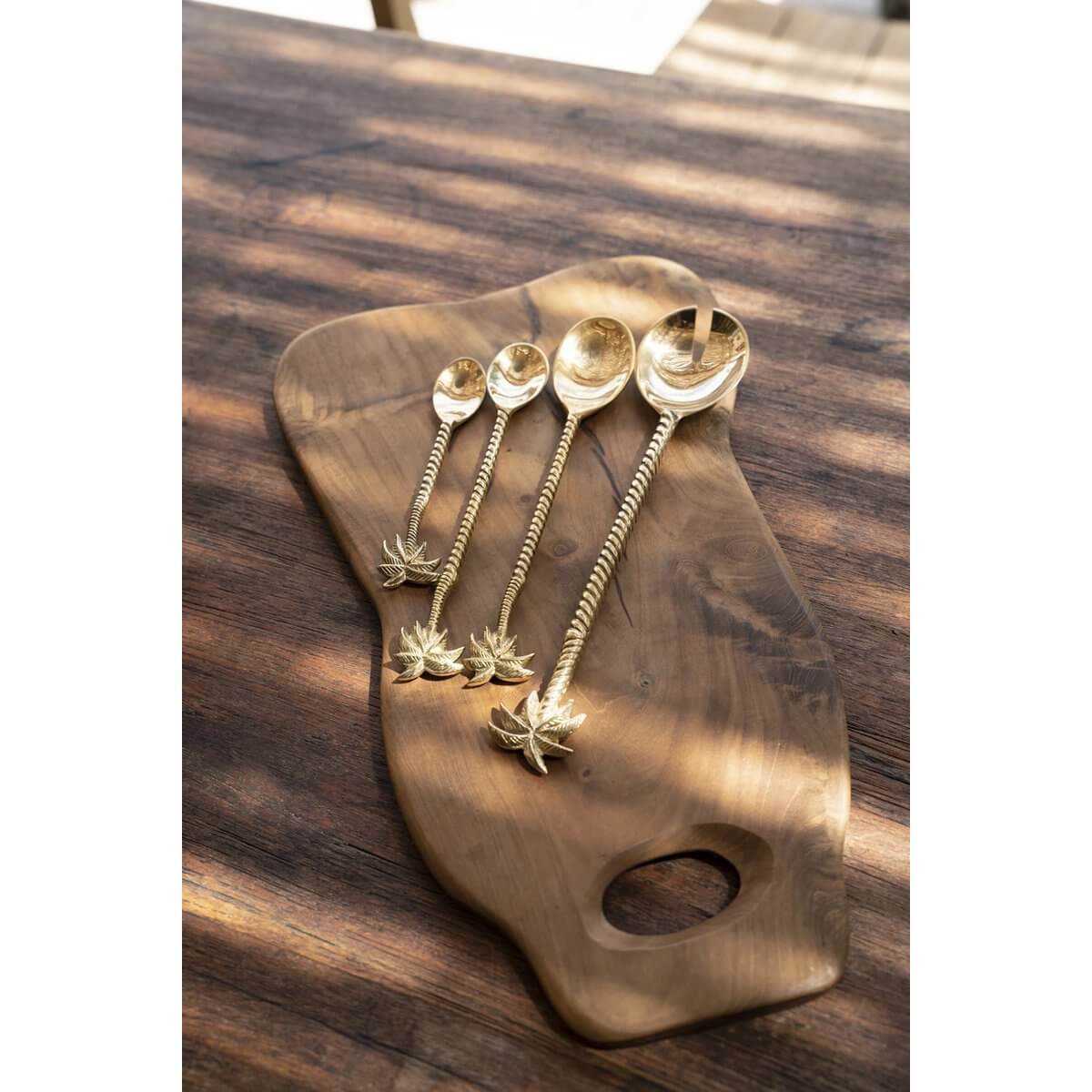 Bohemian gold palm tree spoons on rustic wooden board, perfect for adding tropical flair to your dining experience. Luxe and elegant.
