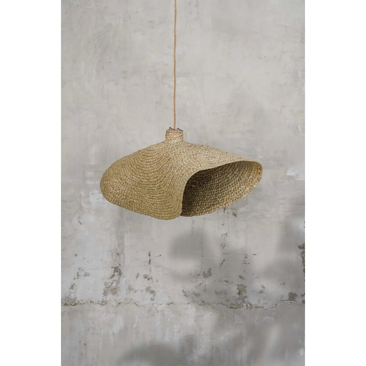 Bohemian De Qubba Hanger XL in naturel finish, made from woven water hyacinth, creating cozy light patterns for a coastal decor feel.