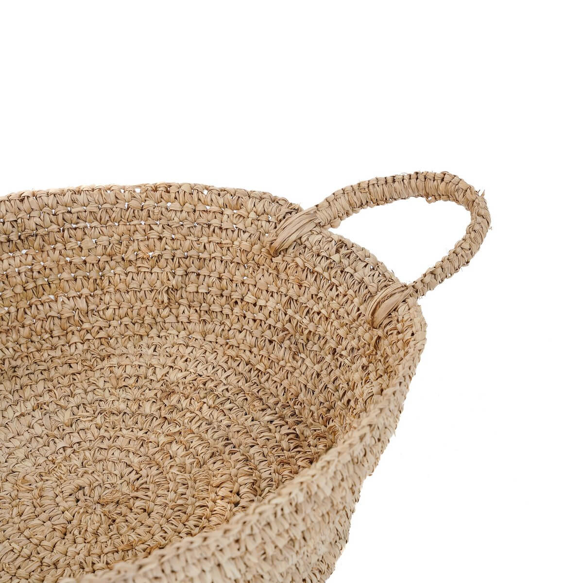 Rustic Bohemian raffia basket with handles, perfect for small spaces, adding warmth and natural charm to your home decor.