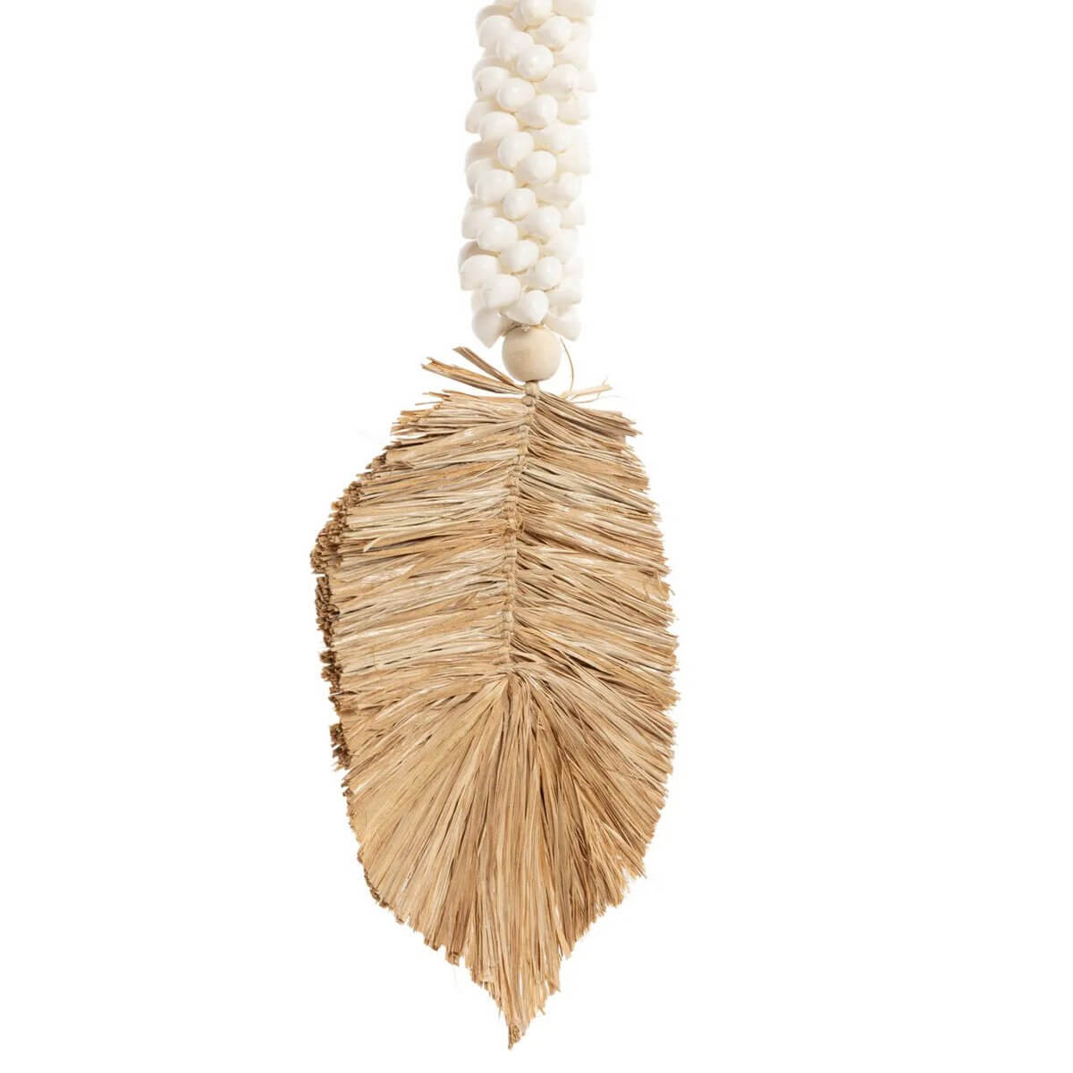 Bohemian raffia and white shell tassel handmade by Balinese artisans, perfect for home decor with an exotic touch.