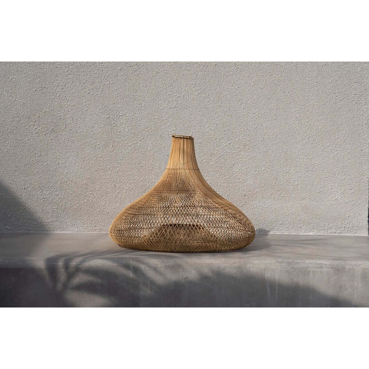 Bohemian-style De Shala lamp made of natural rattan, versatile as hanging or floor lamp, enhancing organic interior aesthetics by Bazar Bizar Living.