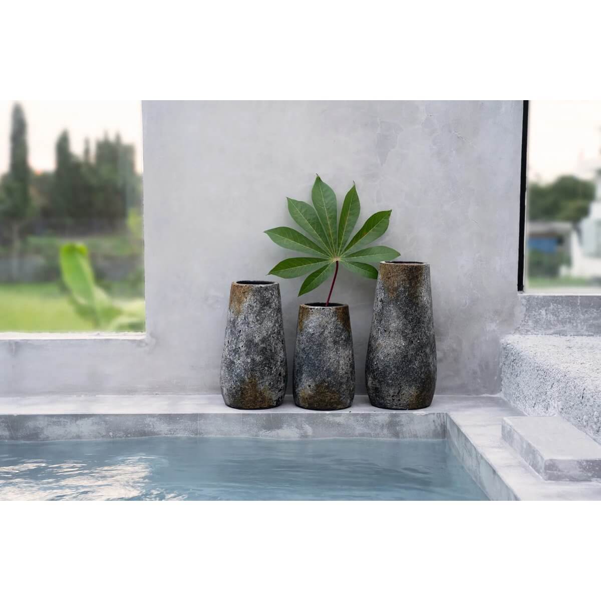 Bohemian antique gray terracotta vases by the pool, perfect for adding charm to any space, made from sustainable materials.
