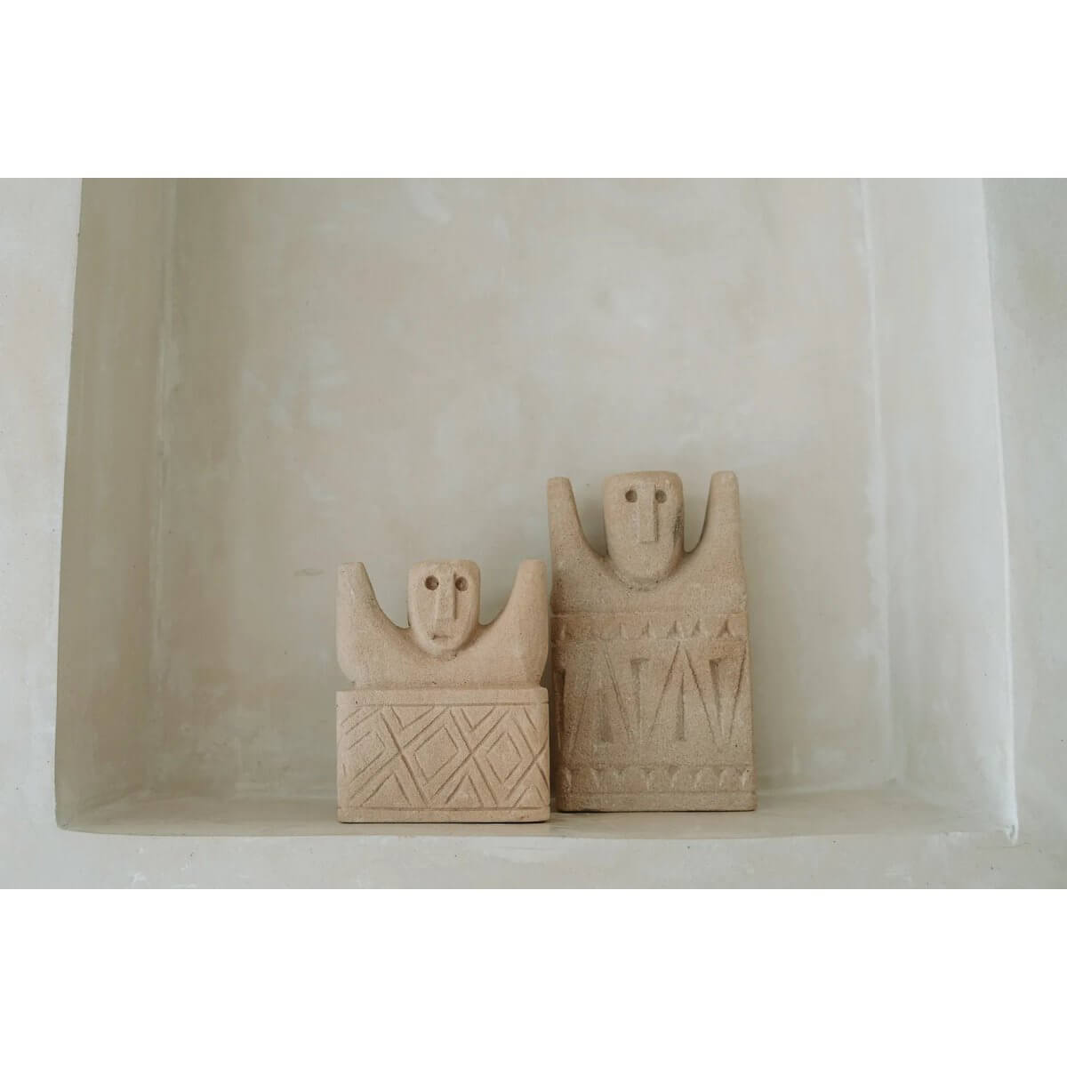 Bohemian Sumba-stone sculptures from Indonesia, hand-carved sandstone figures for home decor protection. Unique artistic statement.