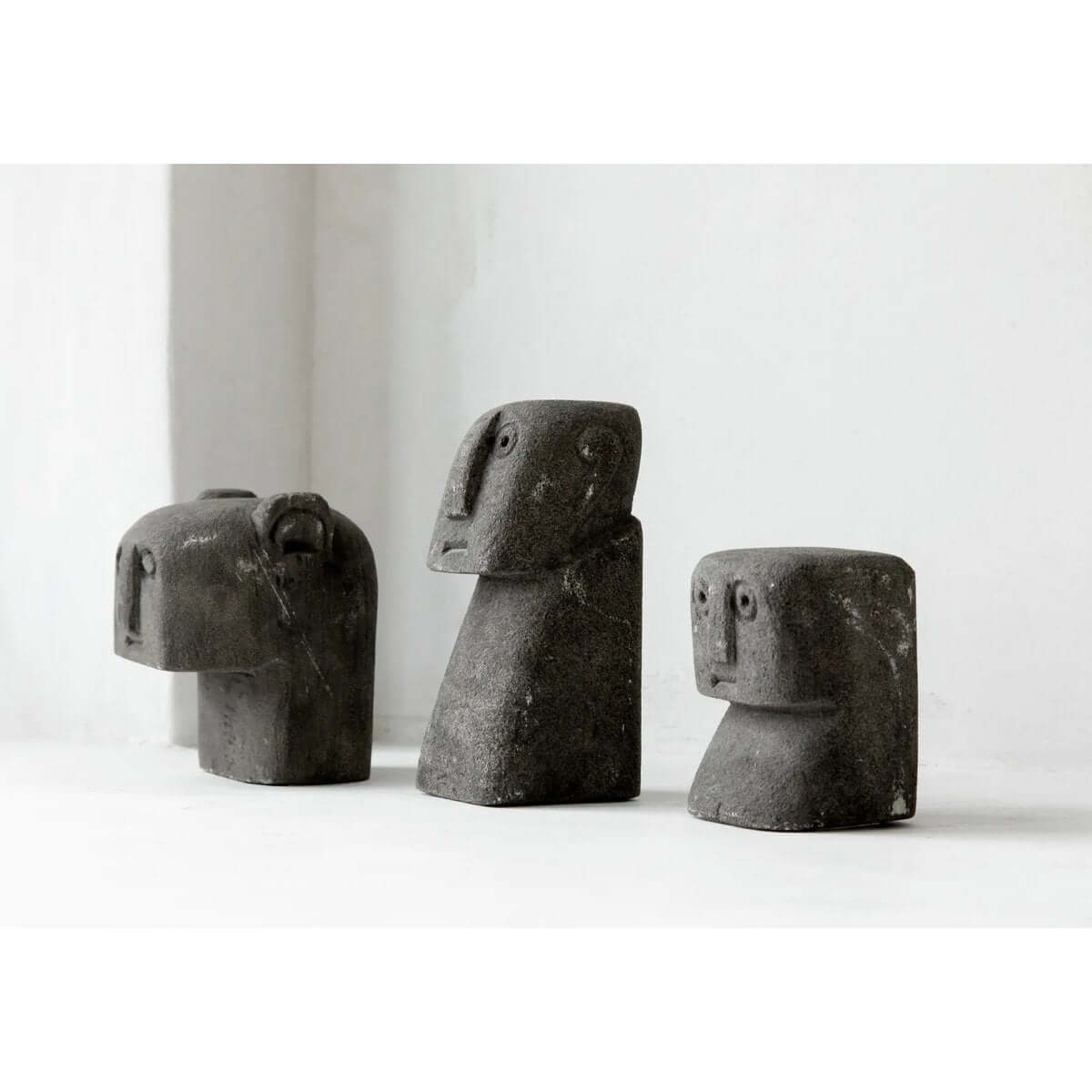 Hand-carved Sumba sandstone figures, perfect for a Bohemian home decor, showcasing traditional Indonesian craftsmanship.