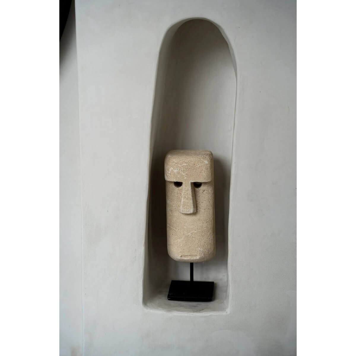 Hand-carved Sumba stone statue on stand, offering bohemian charm and traditional Indonesian craftsmanship