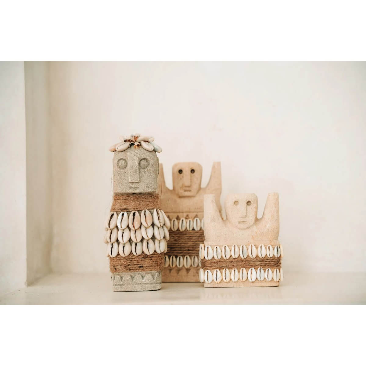 Alt Tag: Bohemian sandstone figures from Sumba, Indonesia, handcrafted with shell details for traditional home protection and healing.