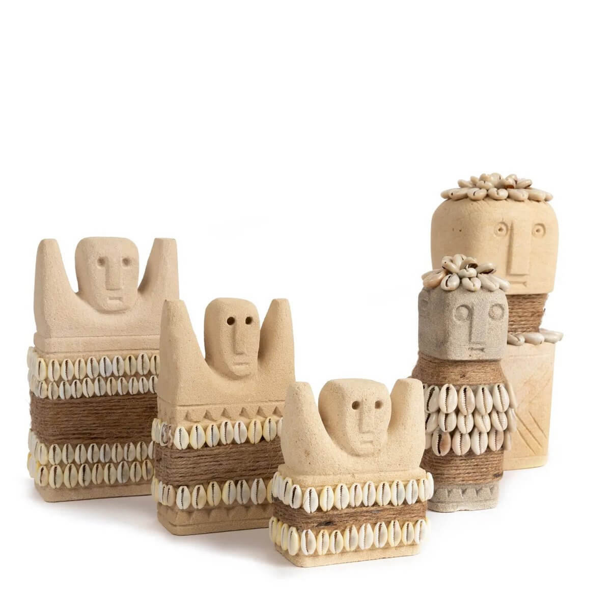 Hand-carved Sumba sandstone statues with seashell accents showcasing Bohemian design and cultural heritage from Indonesia.