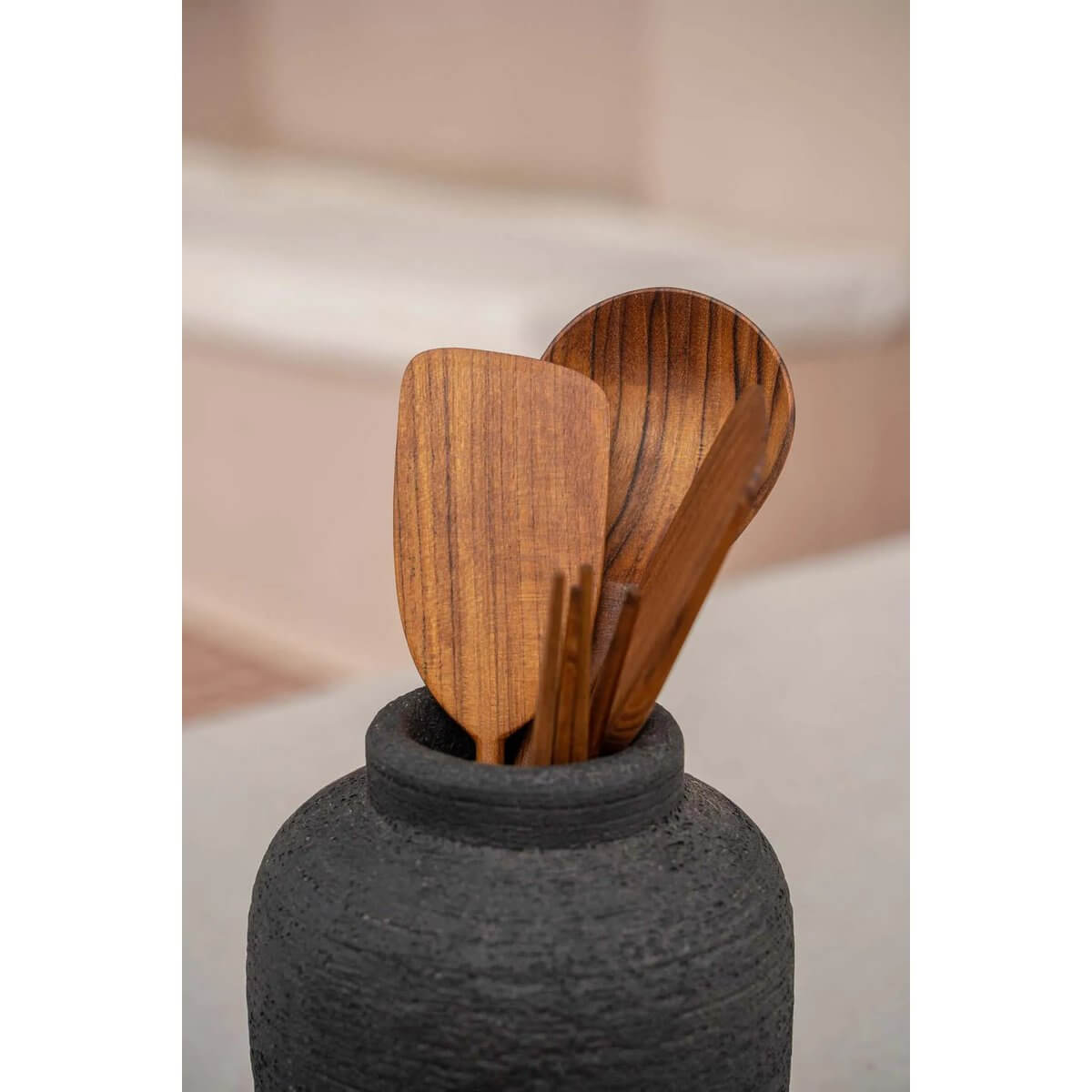 Bohemian style Teak Root Spatula set in black ceramic pot, adds a rustic touch to any kitchen space.