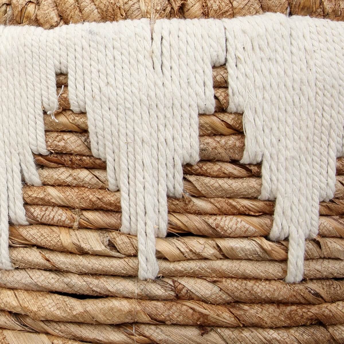 Detail van een duurzaam handgeweven wasmand van bananenblad met katoenen stiksel, bohemian stijl voor modern interieur.