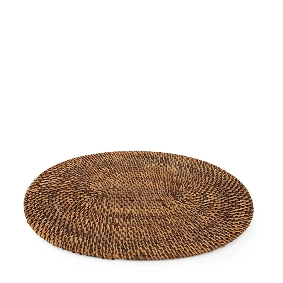 Bohemian-style round handwoven rattan placemat in natural brown, perfect for tropical table settings, by Bazar Bizar Living.