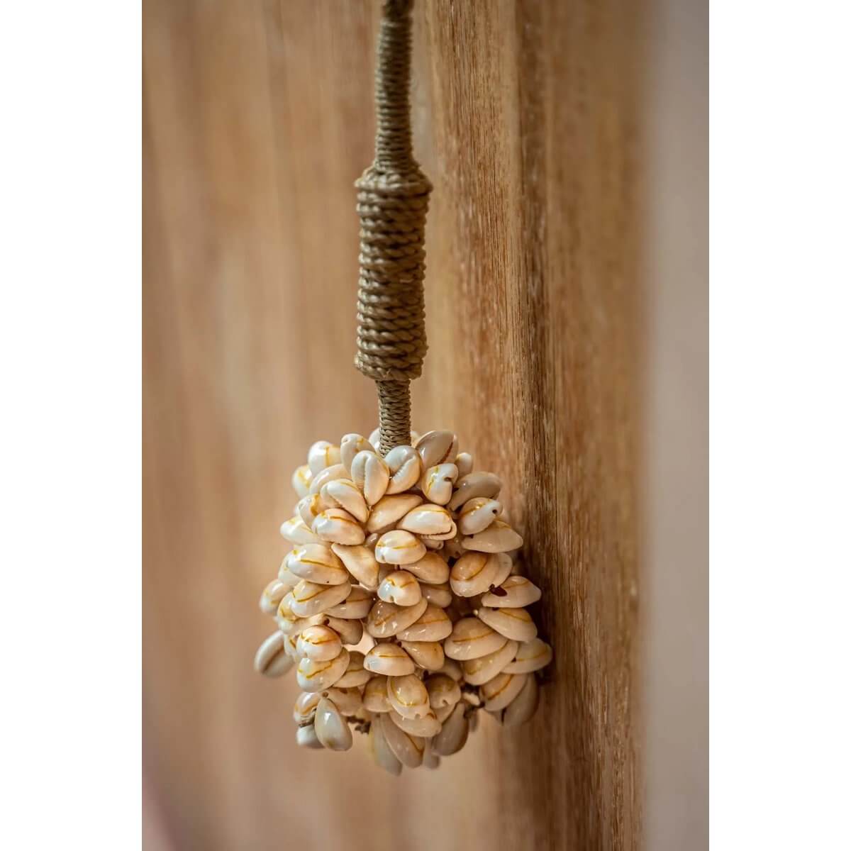 Handcrafted pink shell tassel for bohemian decor by Balinese artisans, perfect for doors, curtains, or walls. Bazar Bizar Living.