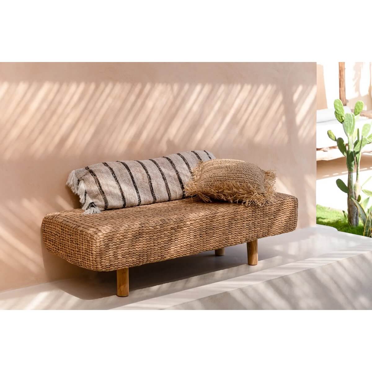 Bohemian waterhyacinth bench with striped and textured cushions, showcasing natural elegance and eco-friendly design.