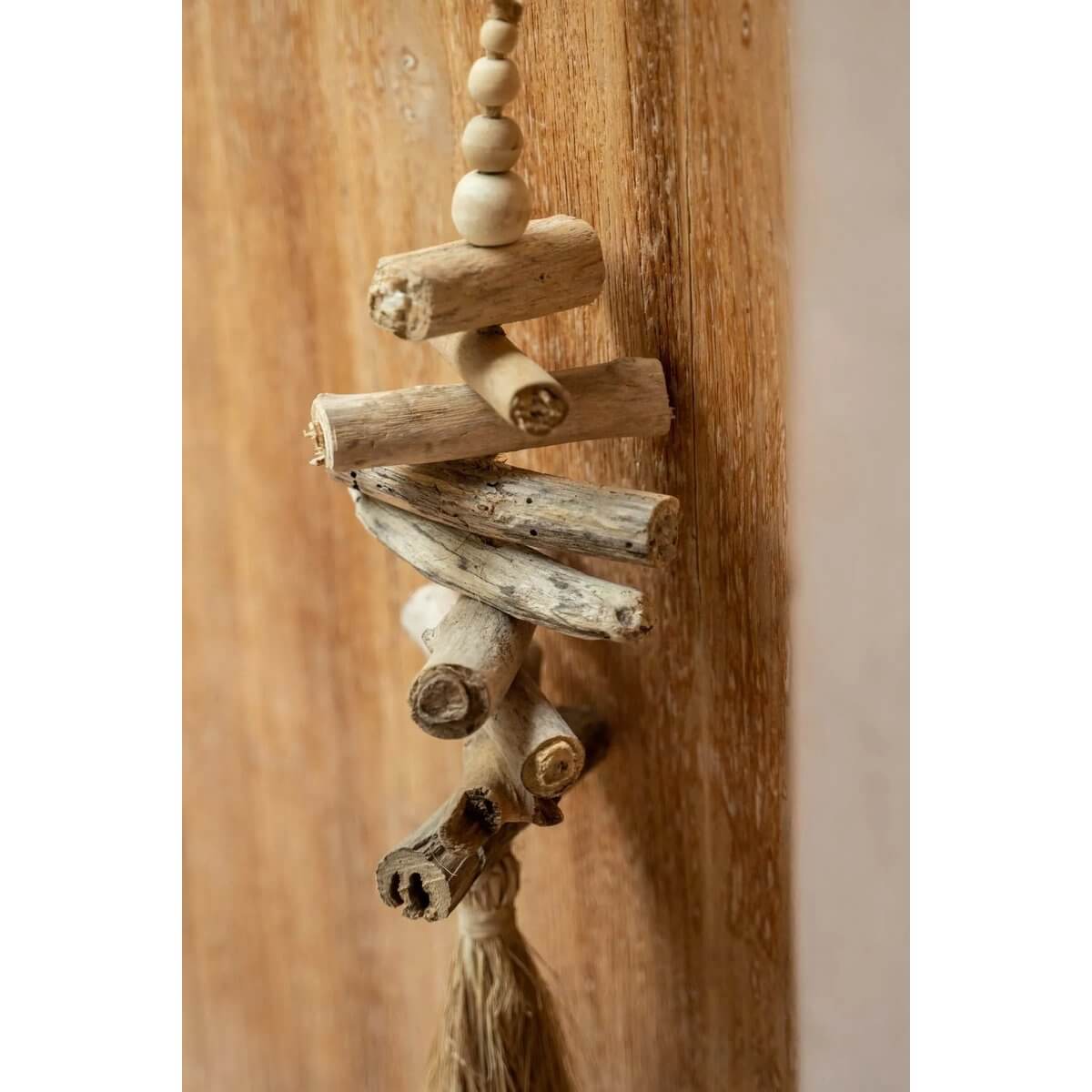 Bohemian raffia and driftwood tassel, handcrafted by Balinese artisans, perfect for exotic home decor; 15cm x 3cm x 60cm.